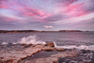 Seascape with splashing waves against dramatic sky