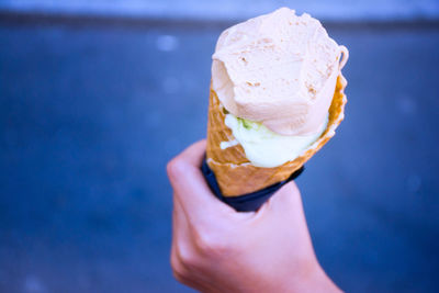 Close-up of hand holding ice cream