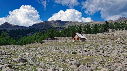 Panoramic shot of building and mountains against sky