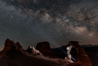 Rock formations against sky at night