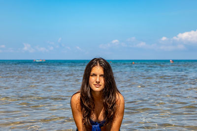 Portrait of woman against sea against sky