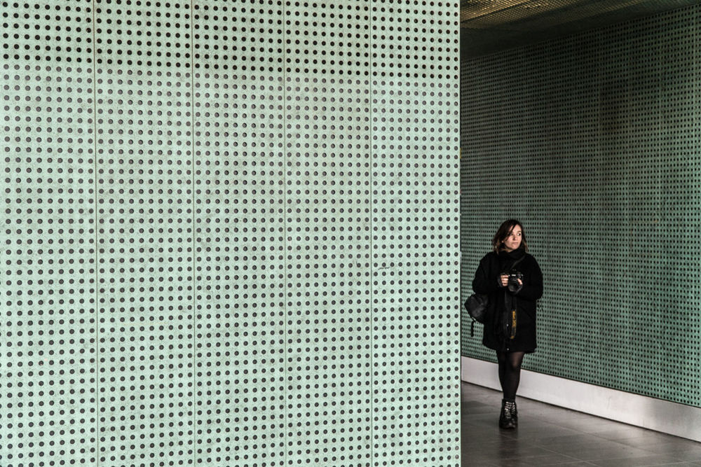 FULL LENGTH OF WOMAN STANDING AGAINST WALL