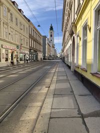 Street amidst buildings in city against sky