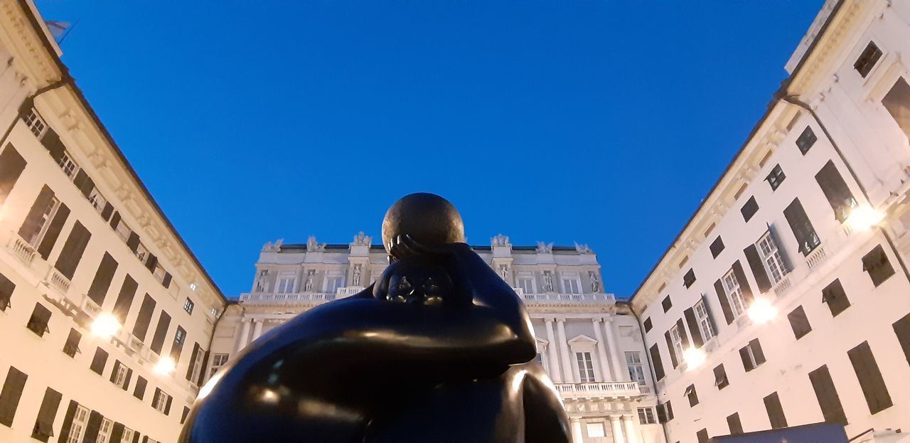 LOW ANGLE VIEW OF BUILDING AGAINST CLEAR BLUE SKY