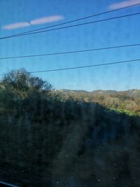 Low angle view of electricity pylon against sky