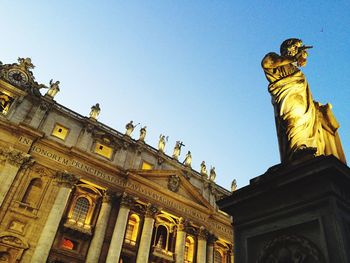 Low angle view of statue against blue sky