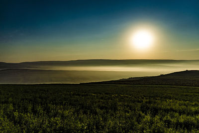 Scenic view of land against sky during sunset