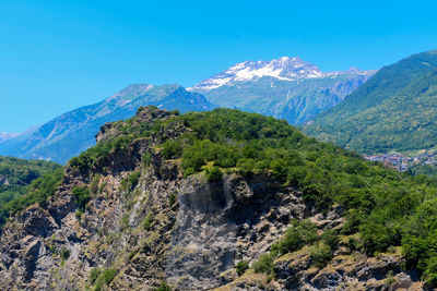 Scenic view of mountains against clear blue sky