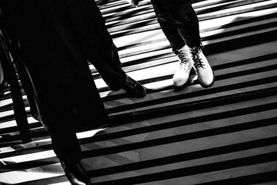 Low section of woman standing on tiled floor