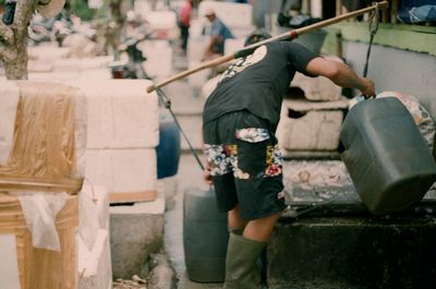 Man working on street in city