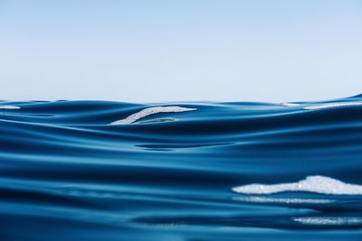 Close-up of water splashing against blue sky