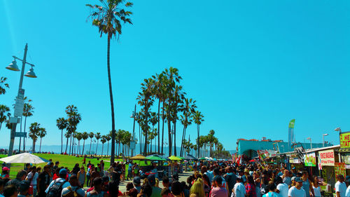 Group of people in city against sky