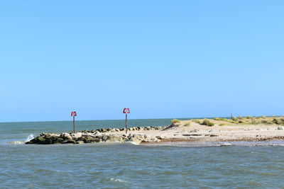 Scenic view of sea against clear blue sky