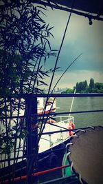 Boat sailing on river against sky