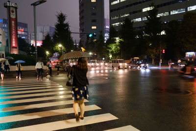 People walking on road at night