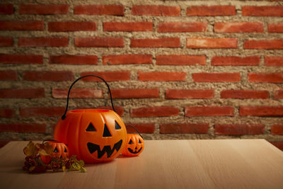 View of pumpkin on table against brick wall