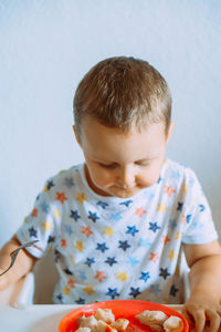 Close-up of boy eating food at home