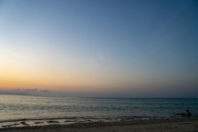 Scenic view of sea against clear sky during sunset