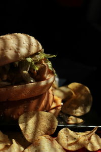 Close-up of bread on table against black background