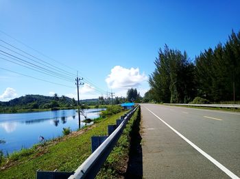 Road by plants against sky