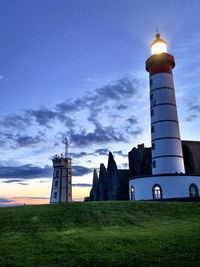 Low angle view of lighthouse against buildings