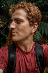 Close-up portrait of mid adult man looking away