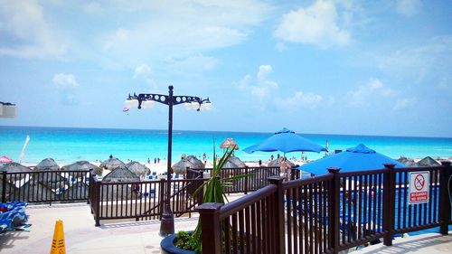 Scenic view of beach against cloudy sky