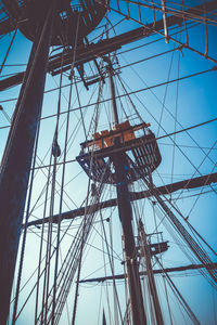 Low angle view of sailboat against clear blue sky