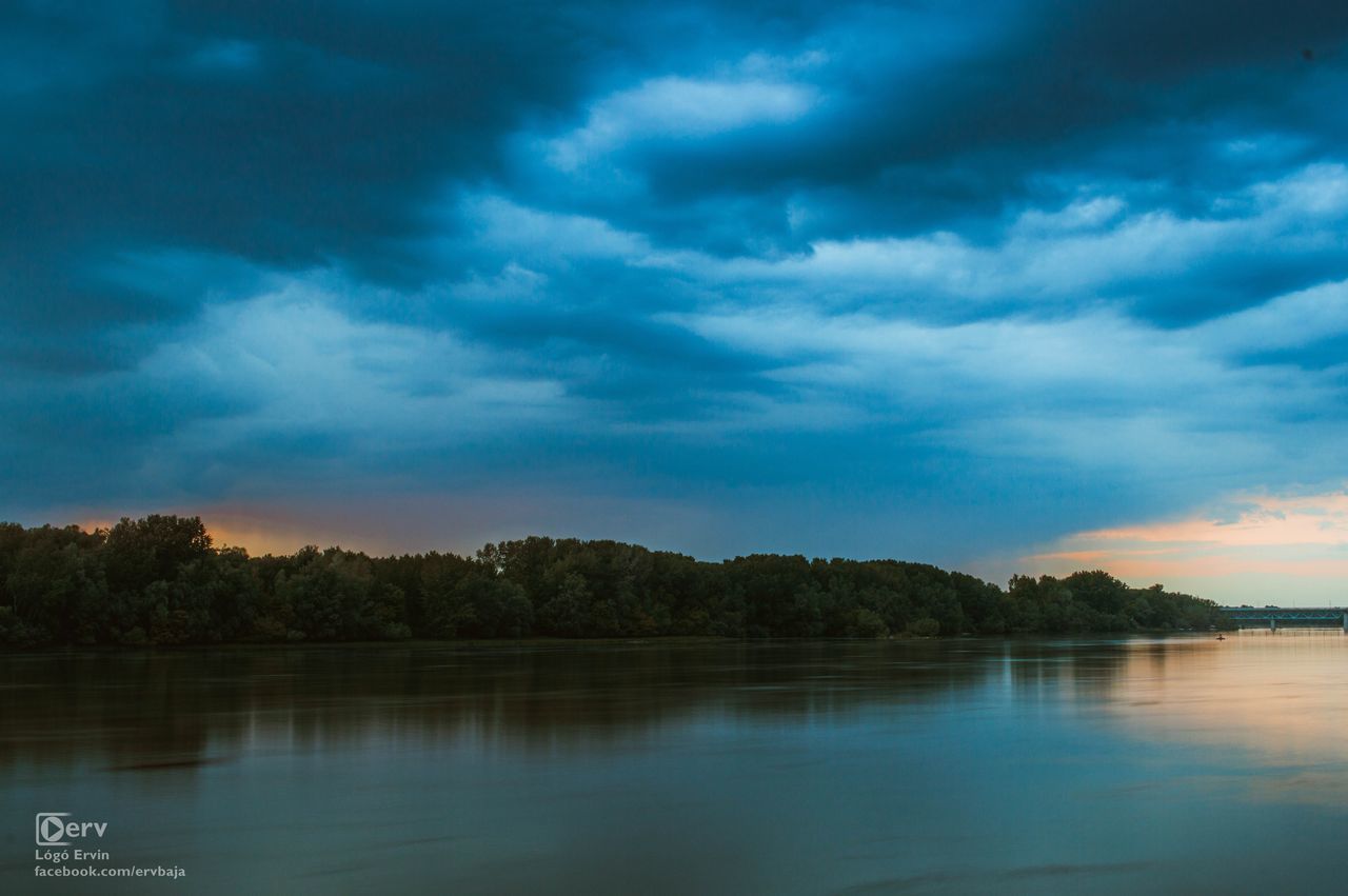 VIEW OF LAKE AGAINST CLOUDY SKY