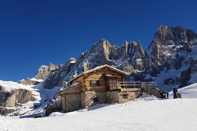 Scenic view of snowcapped mountains against clear blue sky