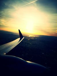 Cropped image of airplane flying over clouds