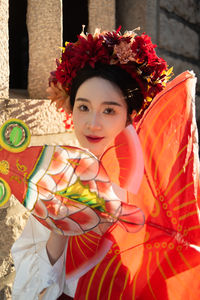 Portrait of smiling young woman holding gift