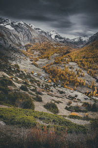 Scenic view of mountain range against cloudy sky