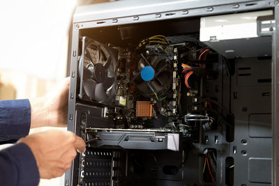 Cropped hand of technician repairing cpu