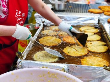 Midsection of woman preparing food at market