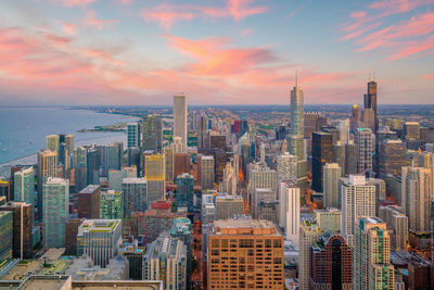 Aerial view of cityscape against sky during sunset