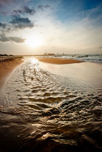 Scenic view of beach against sky during sunset