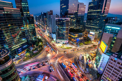 High angle view of illuminated city street and buildings at night