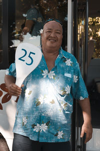 Full length of a smiling young man holding camera