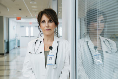 Portrait of confident female doctor standing in hospital lobby