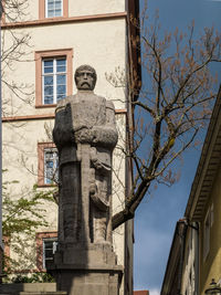 Low angle view of statue against building