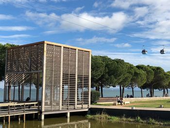 Built structure by trees against sky