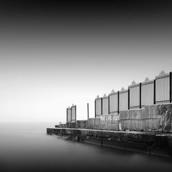 Pier by sea against sky during foggy weather