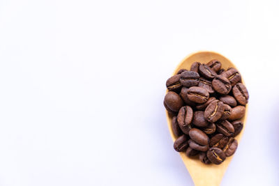 Close-up of coffee beans against white background