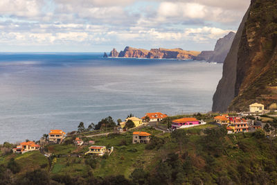 High angle view of buildings by sea against sky