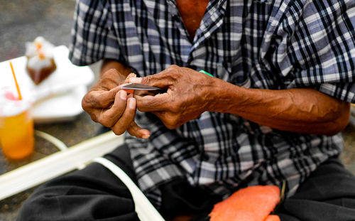 Midsection of man holding scissor