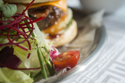 Close-up of salad with burger in plate