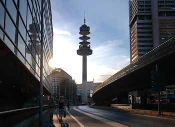 View of city street and buildings against sky