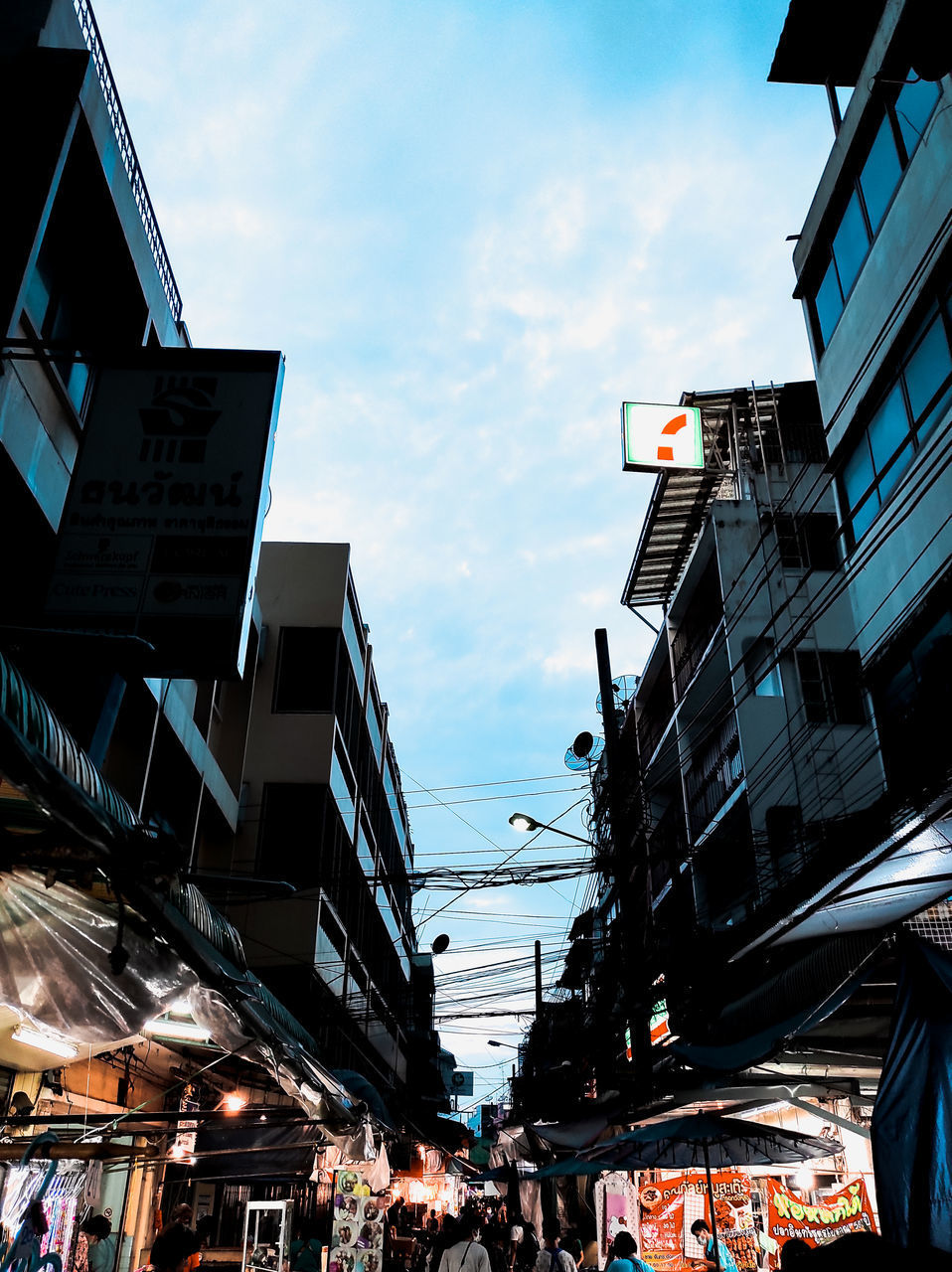 LOW ANGLE VIEW OF ILLUMINATED CITY BUILDINGS AGAINST SKY