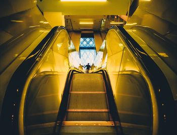 Woman walking on escalator